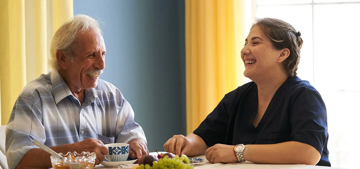 Family Caregiver enjoying meal with his loved one