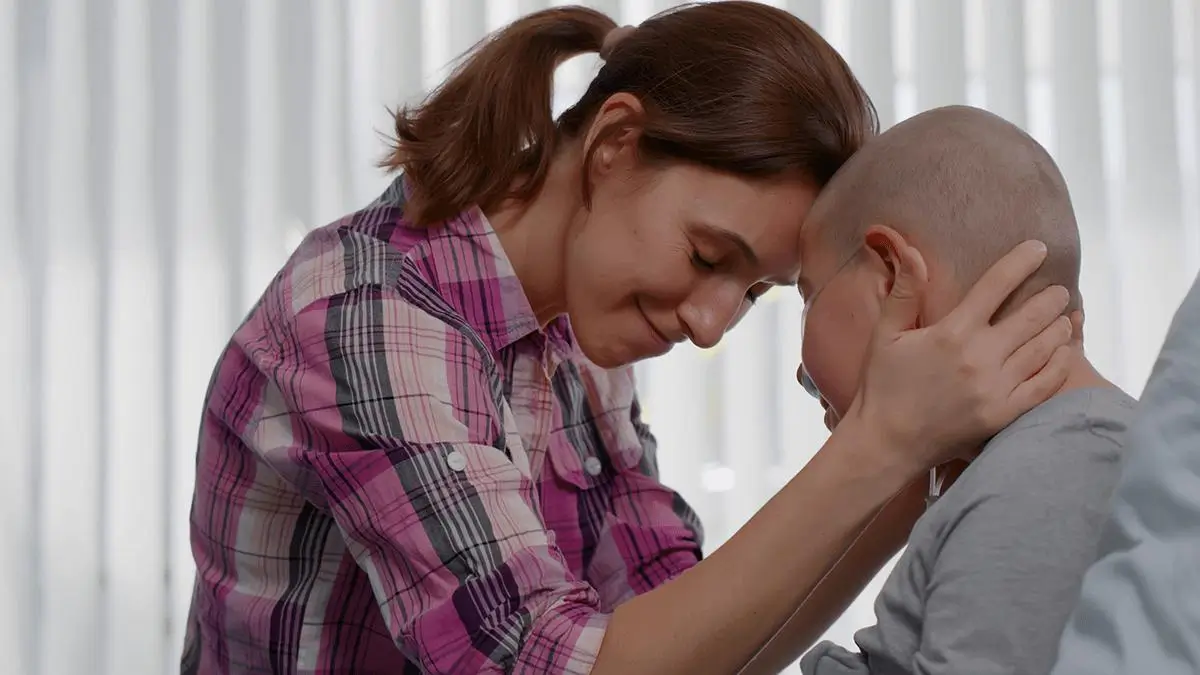 Female caregiver showing kindness to cancer patient Female caregiver showing kindness to cancer patient